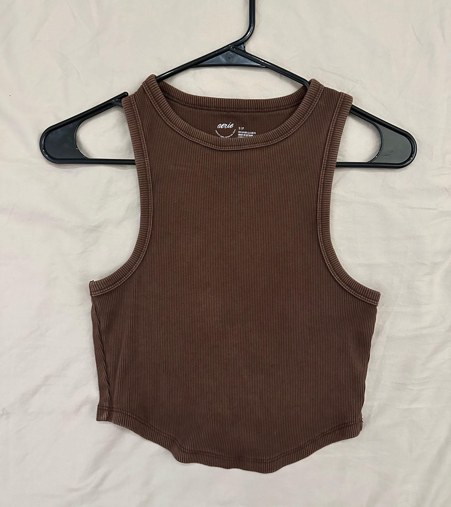 Chocolate-brown ribbed tank laid flat, with fine vertical ribs visible across its matte fabric.