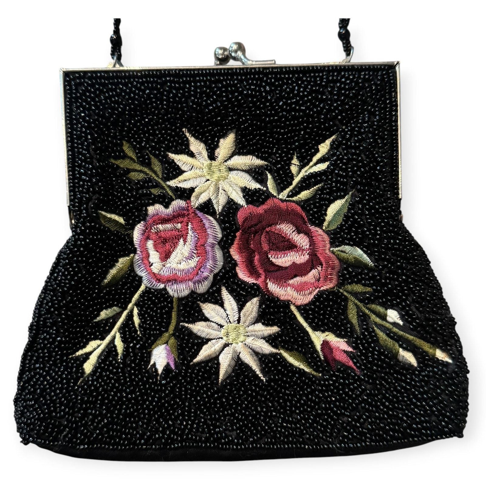Compact black beaded evening bag with embroidered pink roses and white flowers.