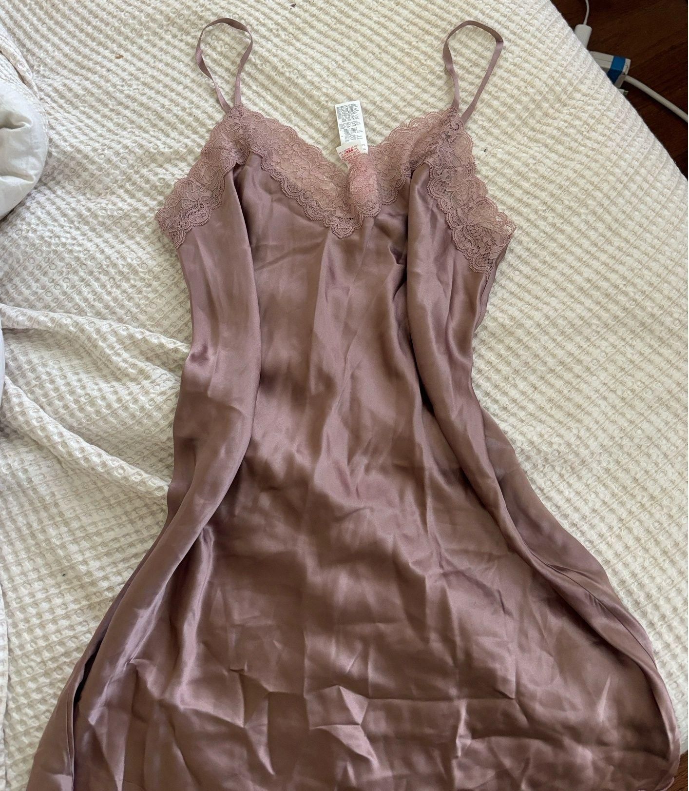 Mauve satin slip dress laid flat, with delicate lace trim and soft folds.