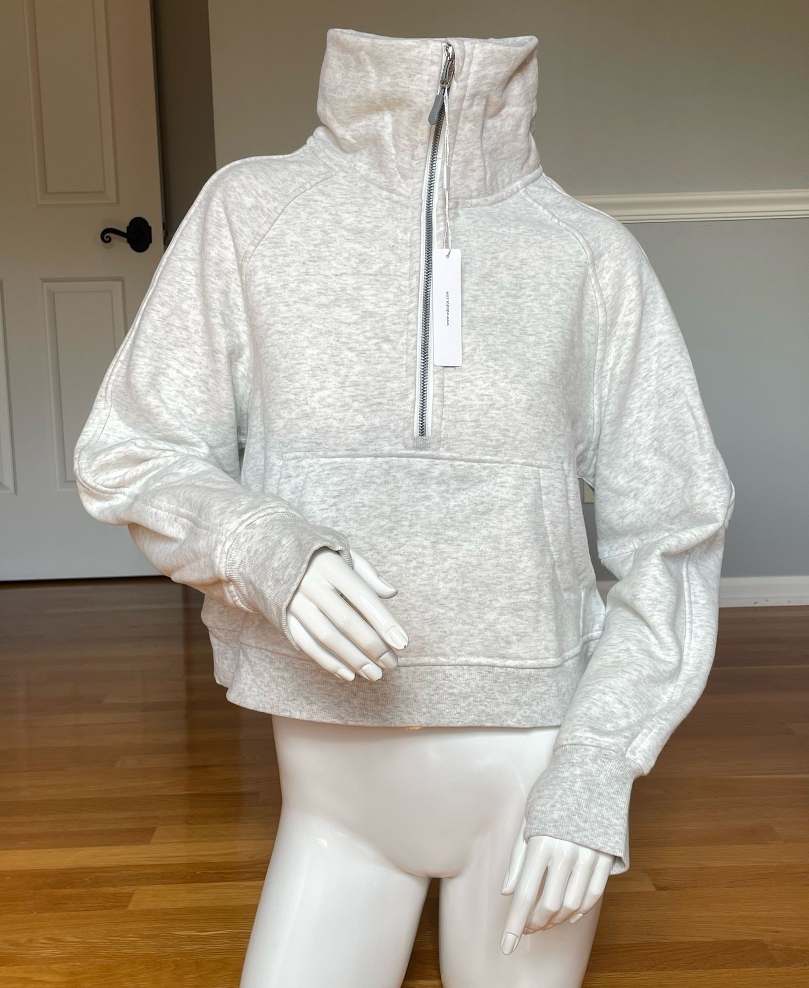 Heathered fleece half-zip sweatshirt with a tall stand-up collar and relaxed fit.