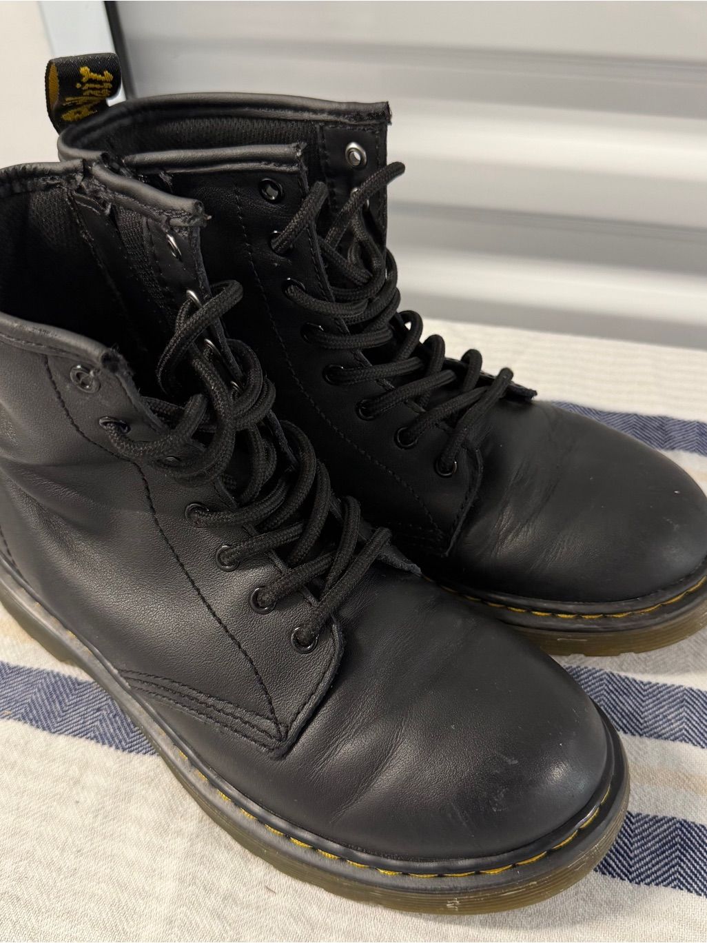 Black lace-up ankle boots with low heels and textured rubber soles, photographed from above.
