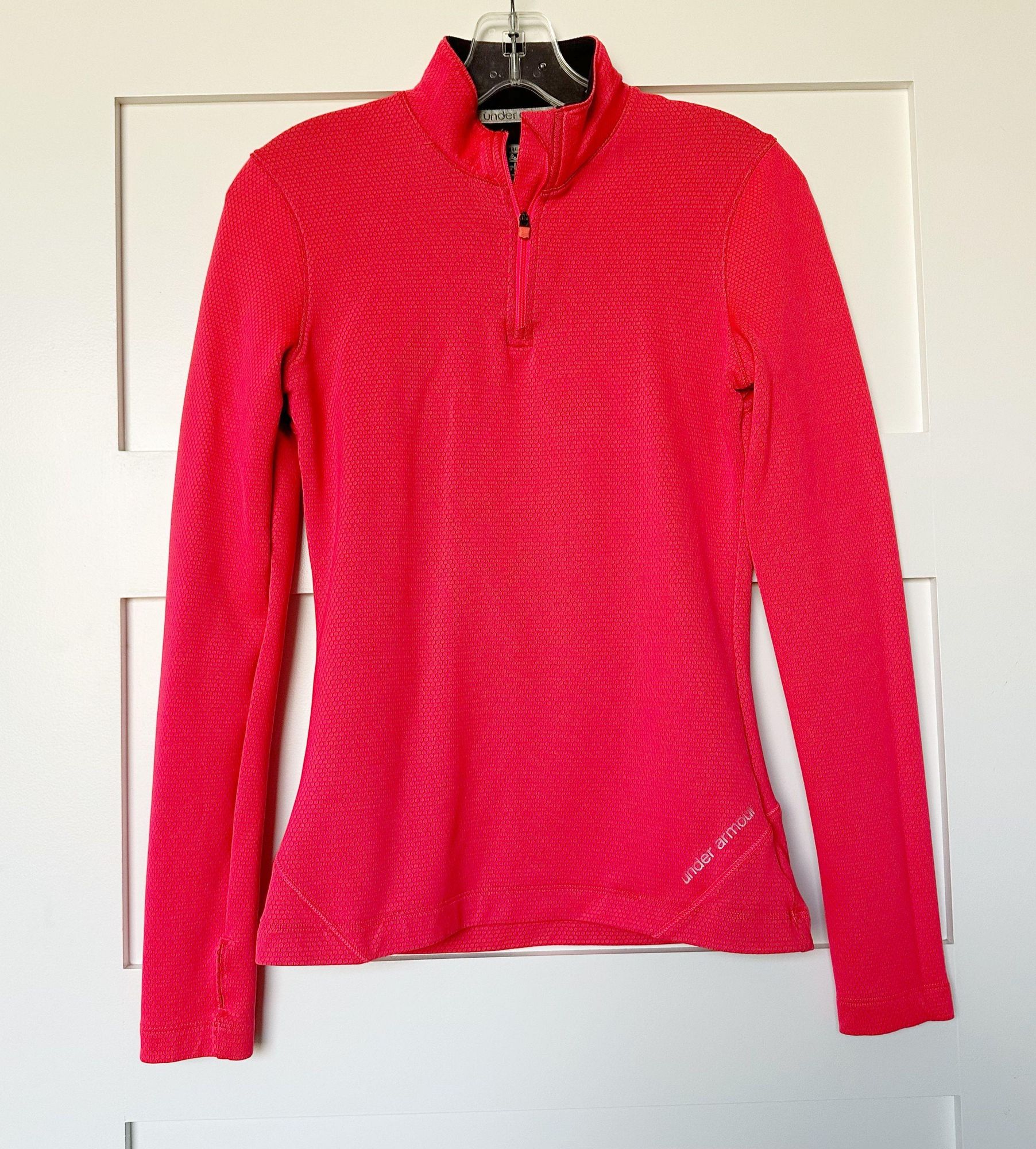 Bright hot-pink long-sleeve quarter-zip top photographed on its own.