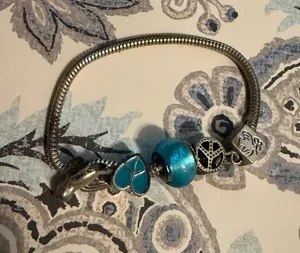 Turquoise Silver Charm Bracelet with Blue Beads birds and peace theme thumbnail 1