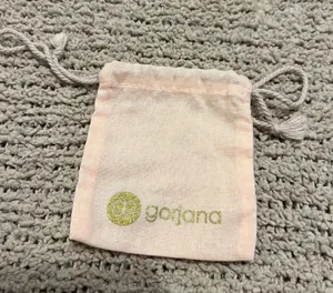 Lightweight blush pink pouch with Gorjana logo. Drawstring closure keeps contents secure. Soft fabric for small jewelry and accessories. thumbnail 1