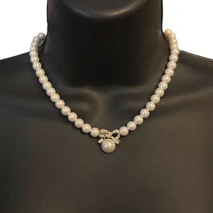 Vintage white pearl rhinestone bow pendant necklace thumbnail 1