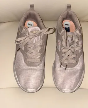 The sneakers are from the U.S. Polo Assn. brand in a pale pink tone with breathable mesh. thumbnail 2