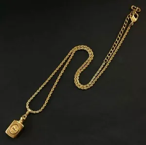 Christian Dior gold perfume bottle necklace with Dior logo thumbnail 1