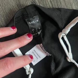 Black and white SHEIN flare pants with white trim #y2kfashion #flares Size 4 Worn once Very soft quality but don't need them anymore thumbnail 3