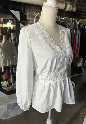 LOS ANGELES white lace V-neck long sleeve shirt top peplum tie cuff New with tag Smoke and pets free Same day shipping Elevate your wardrobe with this stunning white lace blouse from . The V-neckline and long sleeves add a touch of elegance to this top, while the peplum and tie cuff details create a flattering silhouette. The angel character and rose theme make it perfect for any occasion, from casual outings to formal events. Crafted from high-quality lace fabric, this blouse features adjustable features and is available in size S. The solid pattern and delicate lace accents make it a versatile piece that can be paired with any bottom. Whether you're dressing up or down, this Rose & Grey blouse is sure to turn heads. thumbnail 5