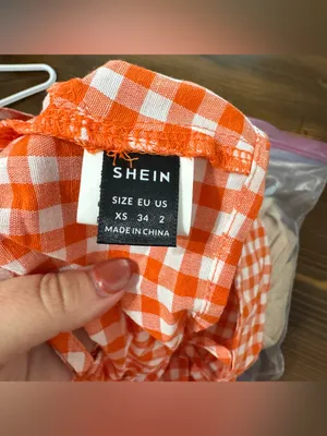 An orange and white gingham crop top with spaghetti straps and a back tie thumbnail 3