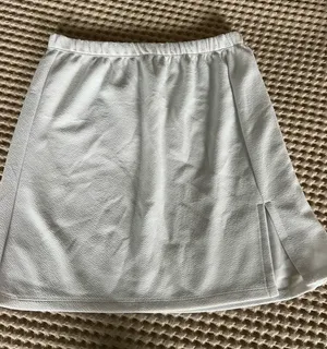 White mini skirt with subtle textured pattern, size S. Polyester & spandex blend. #mini #textured thumbnail 1