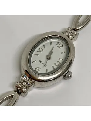 Silver tone women’s quartz analog watch 19mm oval white dial rhinestones running thumbnail 2