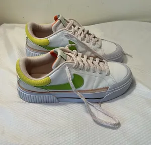 Nike White Low-Top Sneakers with Orange Tongue and Subtle Pink Lining thumbnail 1