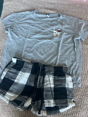 Old Navy Cozy set featuring a gray short sleeve tee with a small "LOVE" graphic. Includes black and white plaid drawstring lounge shorts. Soft, casual pieces perfect for lounging or sleepwear. thumbnail 1