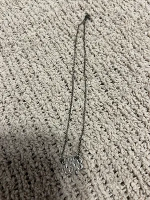 Delicate silver-tone chain with a script monogram pendant. Classic and personalized style. Lightweight and elegant for everyday wear. thumbnail 2