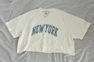 'new york' tee One Size Condition: NWT Color: white / blue Details : - See photos for approx. measurements laying flat - Boxy fit - Comfy - Easy to throw on Extras: - I ship between 1-2 days thumbnail 1