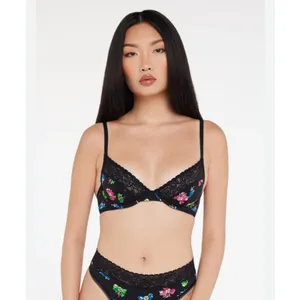 Savage X Fenty Cotton Essentials Unlined Bra Lace Bad Butterfly Black Size S Breathable Fabric: Soft and stretchy signature cotton-jersey body construction for comfortable, all-day lounge or streetwear wear.Unlined Support: Features lightweight, unlined 3-layer underwire cups and supportive wings designed to hug and lift your natural shape without extra bulk.Signature Details: Finished with delicate, tonal scalloped logo lace trim running along the cups.Custom Fit: Features fully adjustable shoulder straps and a classic hook-and-eye back closure with tonal nylon-coated hardware.Materials: Body is 95% Cotton, 5% Elastane; Delicate Lace trim is 82% Polyamide, 18% Elastane.Care Instructions: Hand wash cold, lay flat to dry. thumbnail 2
