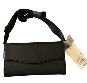 A New Day NWT- Black crossbody bag Faux Leather Adjustable crossbody strap Removable crossbody strap Magnetic closure Inside: zip pocket, credit card pocket and cell phone pocket Measures: 4.25x7.75x1.25 inches thumbnail 1