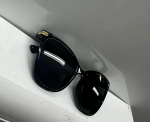 Stylish black sunglasses with gold accents. thumbnail 3