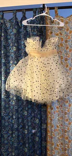 strapless tulle mini dress featuring a cream or light beige mesh fabric adorned with classic black polka dots. It is designed with a heavily ruched, pleated sweetheart bodice, a defined cinched waistband, and a voluminous tiered ruffled skirt. thumbnail 5