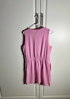 Soft pink sleeveless one-piece with an adjustable drawstring waist for a comfortable fit, with pockets. Lightweight cotton-blend fabric designed for easy movement. Simple, versatile style that pairs well with sneakers or sandals. Member’s mark size large. 57% cotton, 38% polyester, 5% spandex thumbnail 5