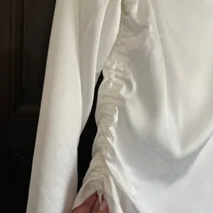 REFORMATION | White Jacquard Satin Allira Asymmetrical Off Shoulder Blouse | 0 thumbnail 4