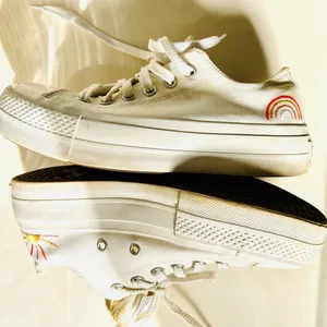 Ivory Converse sneakers with vibrant sun & rainbow side embroidery. thumbnail 1