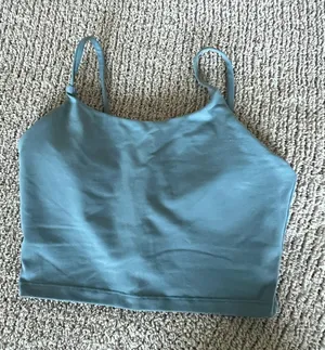 Amazon The Women's Blue Square Neck Activewear Tank Top is a stylish and comfortable piece perfect for active women. With its sleeveless design and spaghetti straps, this camisole features a square neckline for added versatility. Made for activewear occasions, this solid blue tank in size S offers a chic and practical option for women looking for a blend of style and functionality in their wardrobe. thumbnail 1
