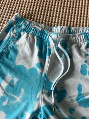 Comfortable aqua and white tie-dye joggers. Elastic waistband with drawstring for a secure fit. Side pockets and ribbed cuffs for everyday wear. Soft fabric keeps relaxed and stylish in aqua pattern. thumbnail 2