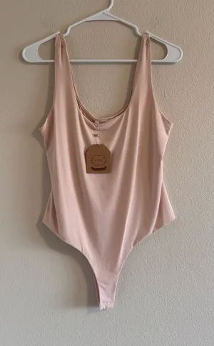 NWT Kori Pale Pink Stretch One-Piece Bodysuit thumbnail 1
