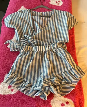Amazon Stylish blue and white striped romper with ruffle details. Perfect for casual outings. thumbnail 1