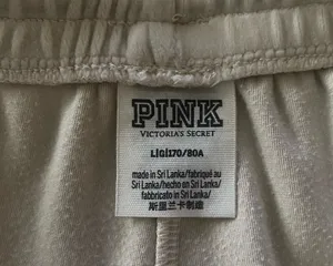 PINK Victoria's Secret Cream Velour Lounge Pants-size large Casual lounge pants from PINK by Victoria's Secret. Elastic drawstring waistband for a comfy fit. Smooth fabric with a relaxed wide-leg silhouette, has hand pockets, embroidered “pink” on one leg, 93% polyester and 7% elasttane, excellent condition Measurements: Waist: side to side 17-21 inches Rise: 11 inches Inseam: 30 inches thumbnail 9