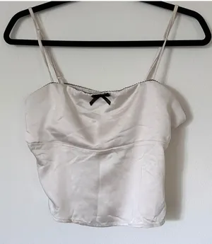 Elegant Cream Satin Camisole Top with Black Bow Accent thumbnail 1