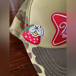 camouflage-patterned Miller High Life trucker hat featuring embroidered patches. thumbnail 2