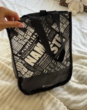 Lululemon black tote bag with white text graphics thumbnail 1