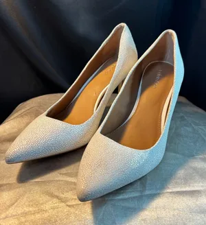 Calvin Klein White Textured Pointed Toe Stiletto Pumps Heels Silver Logo Accent thumbnail 1