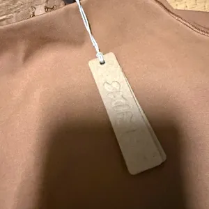 SKIMS All in One Long-Sleeve Mid Thigh Jumpsuit Onesie in Caramel new with tags thumbnail 8