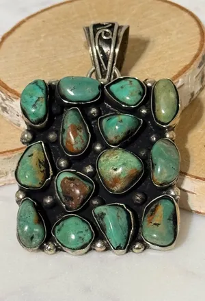 Turquoise cluster pendant set in Tibetan Silver. 14 nuggets, 2”x2” thumbnail 1
