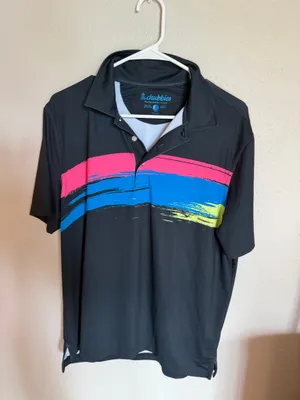 Chubbies Men's Performance Polo Shirt Size Small - Excellent Like New Description Upgrade your weekend wardrobe with this men’s Chubbies performance polo shirt in an excellent, like new condition (Size Small). Featuring a sleek black base with a vibrant pink, blue, and neon yellow brushstroke graphic wrap-around design, this shirt delivers the ultimate casual vibe. Made from a premium, ultra-comfortable 88% polyester and 12% spandex blend, it offers the perfect stretch for golf, resort wear, or casual outings. Lightly worn with no visible flaws—looks exactly as pictured. Fast shipping! thumbnail 1