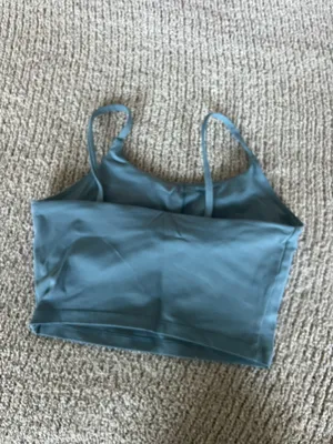 Amazon The Women's Blue Square Neck Activewear Tank Top is a stylish and comfortable piece perfect for active women. With its sleeveless design and spaghetti straps, this camisole features a square neckline for added versatility. Made for activewear occasions, this solid blue tank in size S offers a chic and practical option for women looking for a blend of style and functionality in their wardrobe. thumbnail 2