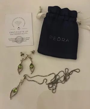 Silver necklace and earrings set with green gemstones thumbnail 1