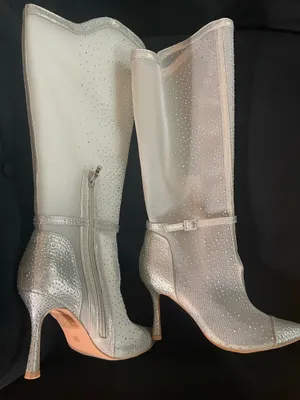 Studio Infinite Elegant silver knee-high boots with all-over rhinestone embellishments. Sleek zip closure and ankle strap for a secure fit. Shiny & sheer silver finish adds a glamorous touch to evening looks. Size 7.5W thumbnail 1