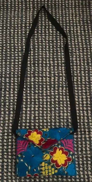 Blue and yellow crossbody bag with a unique, hand-sewn design No flaws and perfect condition/never used Zipper and additional pockets inside thumbnail 1