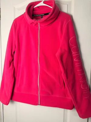 Calvin Klein fleece teddy jacket in vibrant hot pink. Full-zip front with stand collar. Side pockets for hands. Subtle branded detail on the sleeve. Soft, cozy finish for everyday wear. thumbnail 1