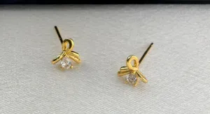 Small CZ Bow Stud Earrings for Women Gold thumbnail 3