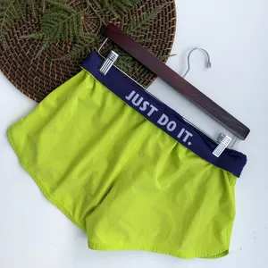 Nike Women’s Shorts Dri-Fit Fold Over Yellow Purple Medium thumbnail 1