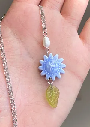 Handmade unique funky cute light blue ceramic sun & Czech glass leaf & freshwater pearl necklace☀️🌿 thumbnail 1