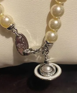 Vivienne Westwood faux pearl and Saturn orb pendant choker, new. thumbnail 6