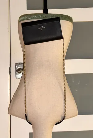 Kate Spade New York Darcy Chain Wallet Crossbody in black. thumbnail 1