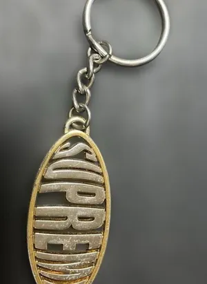 Supreme Two-Tone Oval Logo Keychain — Silver & Gold thumbnail 1